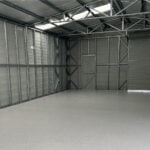 A large warehouse with a restored epoxy floor.