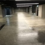 A restored concrete floor in an empty parking garage.