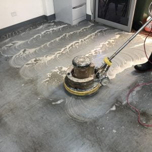 A man cleaning a floor with a machine.