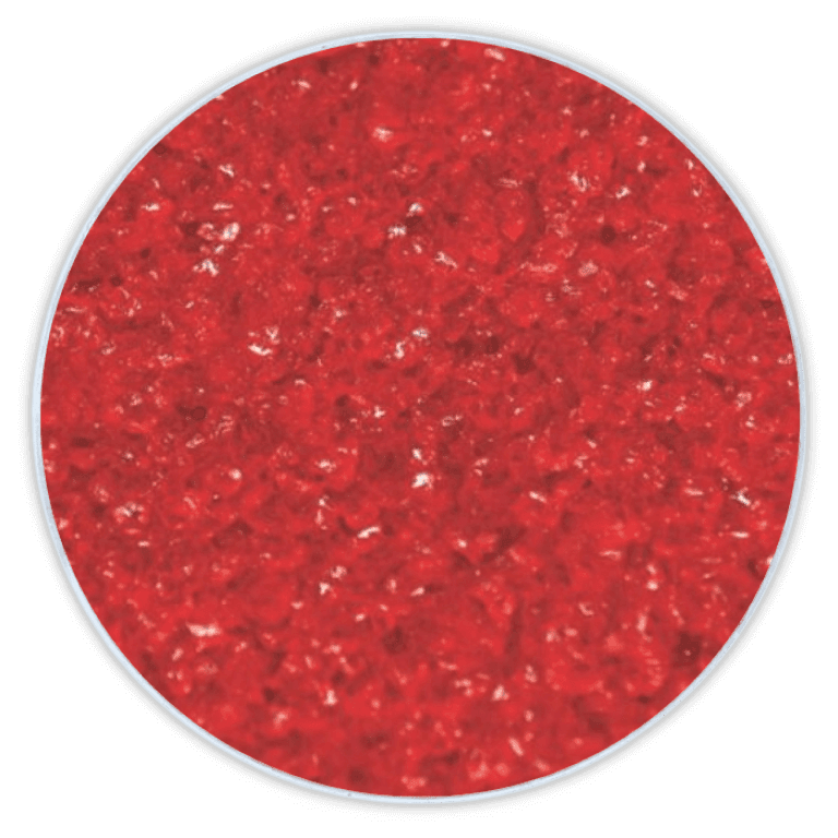 Close-up of bright red, coarsely ground powder in a circular frame against a black background.