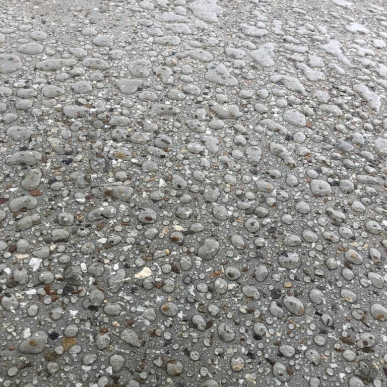 A close up of an waterproof epoxy floor with water droplets on it.