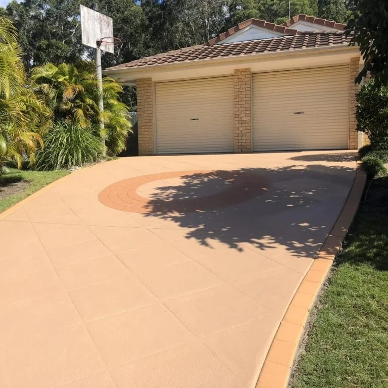 A new driveway with a basketball court in the background.