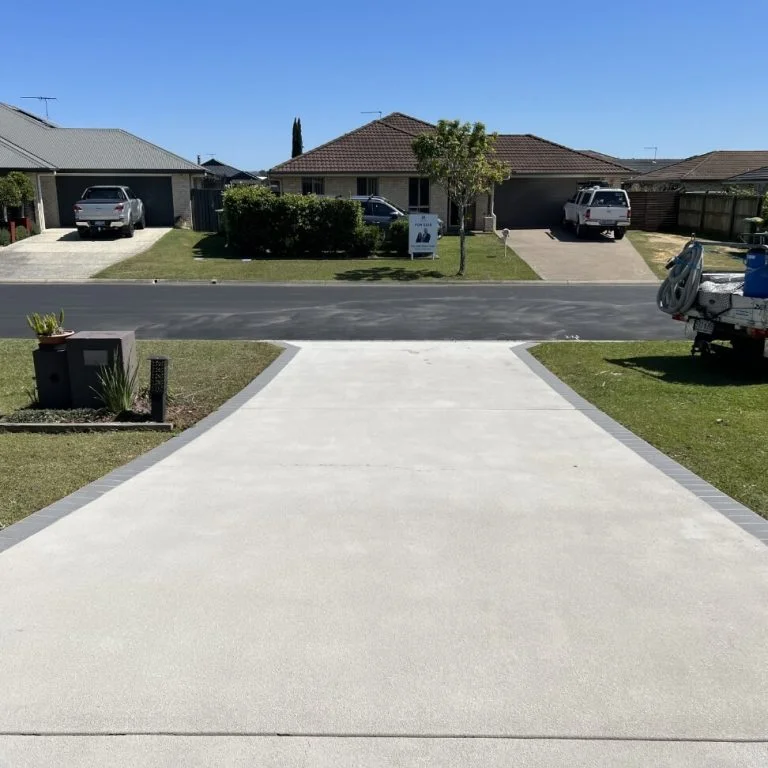A restored driveway in a residential area with a car parked next to it.