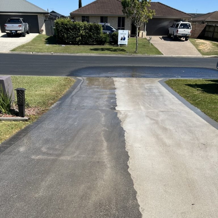 A driveway is being cleaned in a residential area.