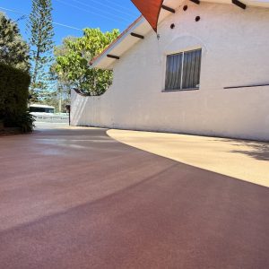 A restored concrete driveway with a tree in the background.