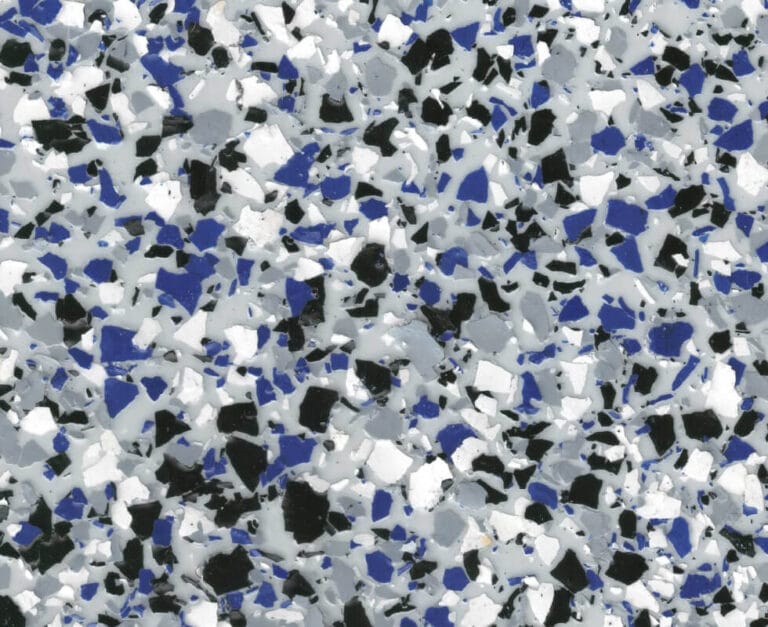 Close-up of a terrazzo surface with scattered fragments in black, white, gray, and blue.