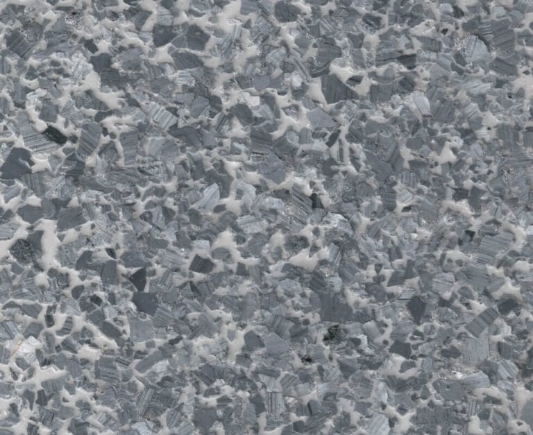 Close-up of a polished granite surface featuring a mix of gray, white, and black crystalline patterns.