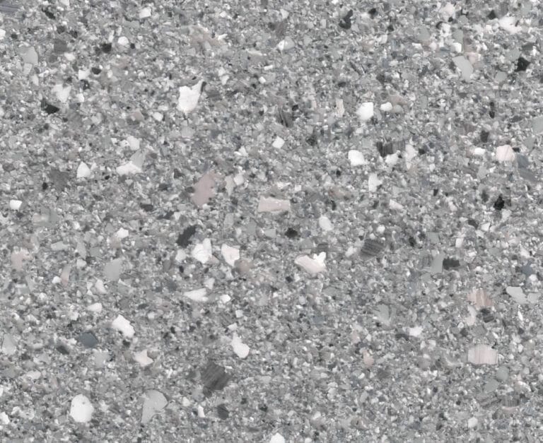 Close-up of a grey terrazzo floor surface, featuring a speckled pattern with white and black marble chips.