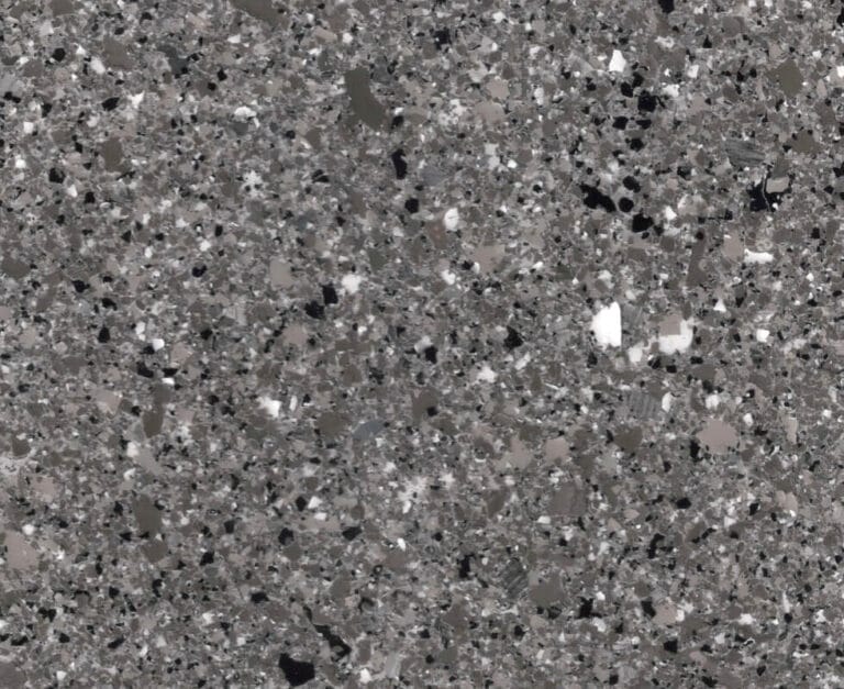 Close-up of a speckled gray and black terrazzo surface with white accents, displaying a polished and textured finish.