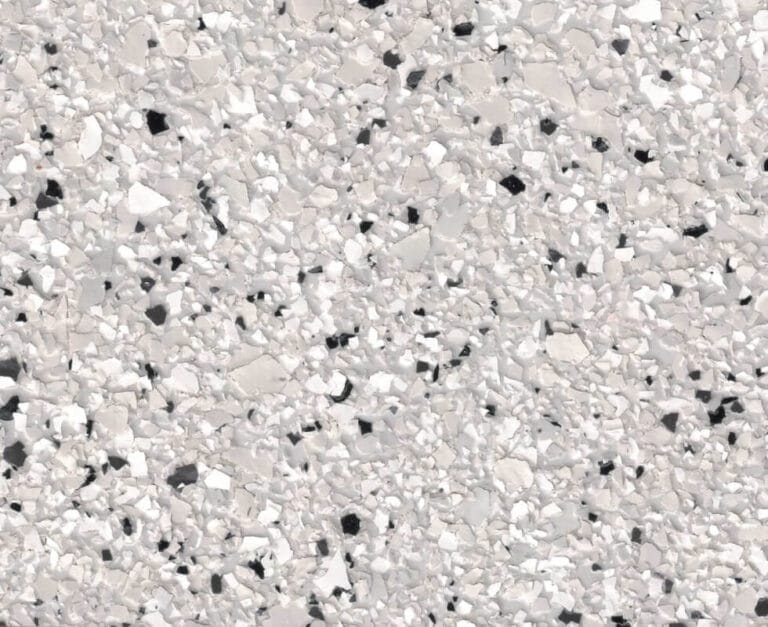 Speckled white and gray terrazzo flooring with various irregularly shaped chips embedded in a light background.