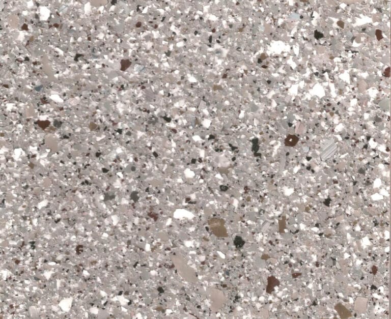 Close-up of a terrazzo surface with a mix of gray, white, and brown stone fragments embedded in a light gray matrix.