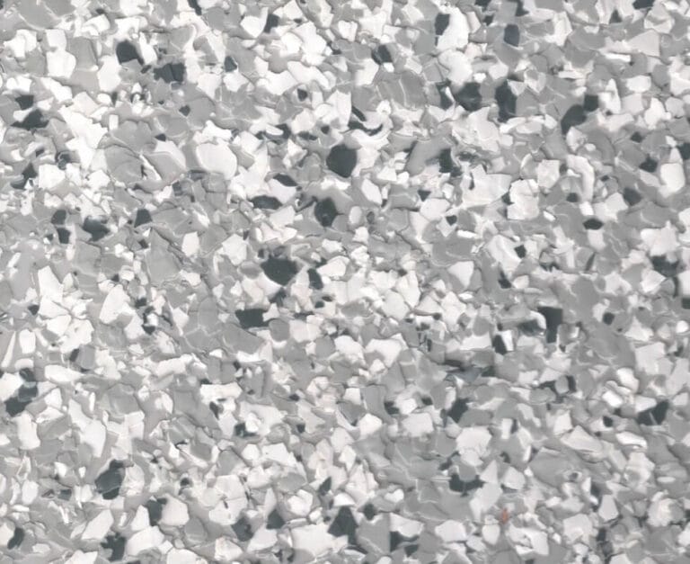 Close-up of a terrazzo floor with a mix of gray, white, and black stone chips.